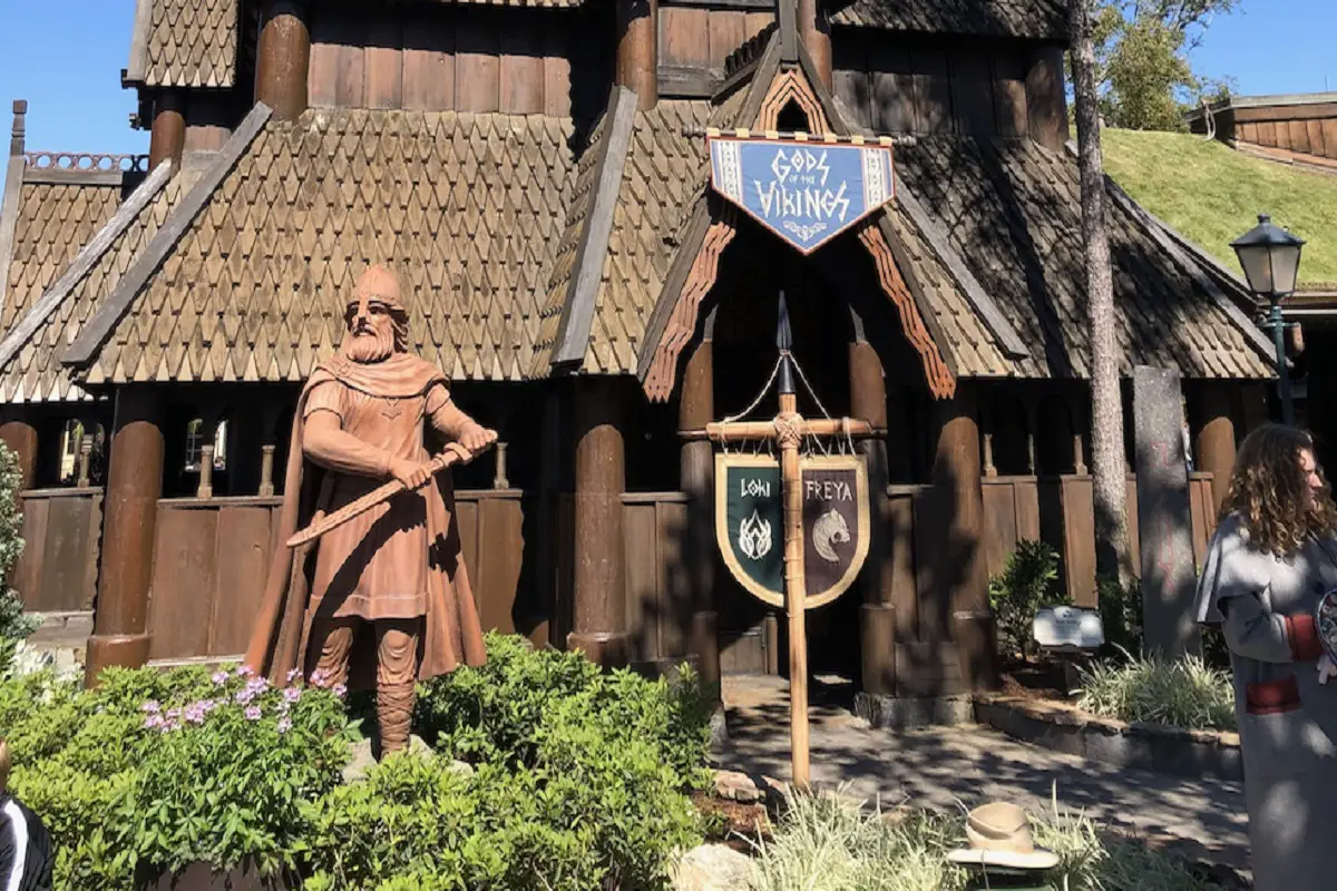 Front of the Norway Pavilion attraction with a focus on its classic Nordic architecture and statue of a warrior with a sword in his left hand
